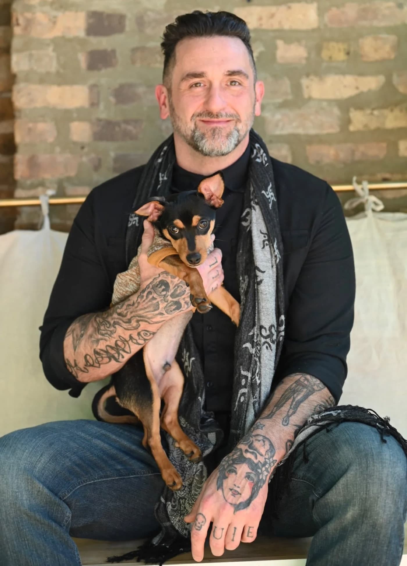 Shane Schwartz holding Diego the dog