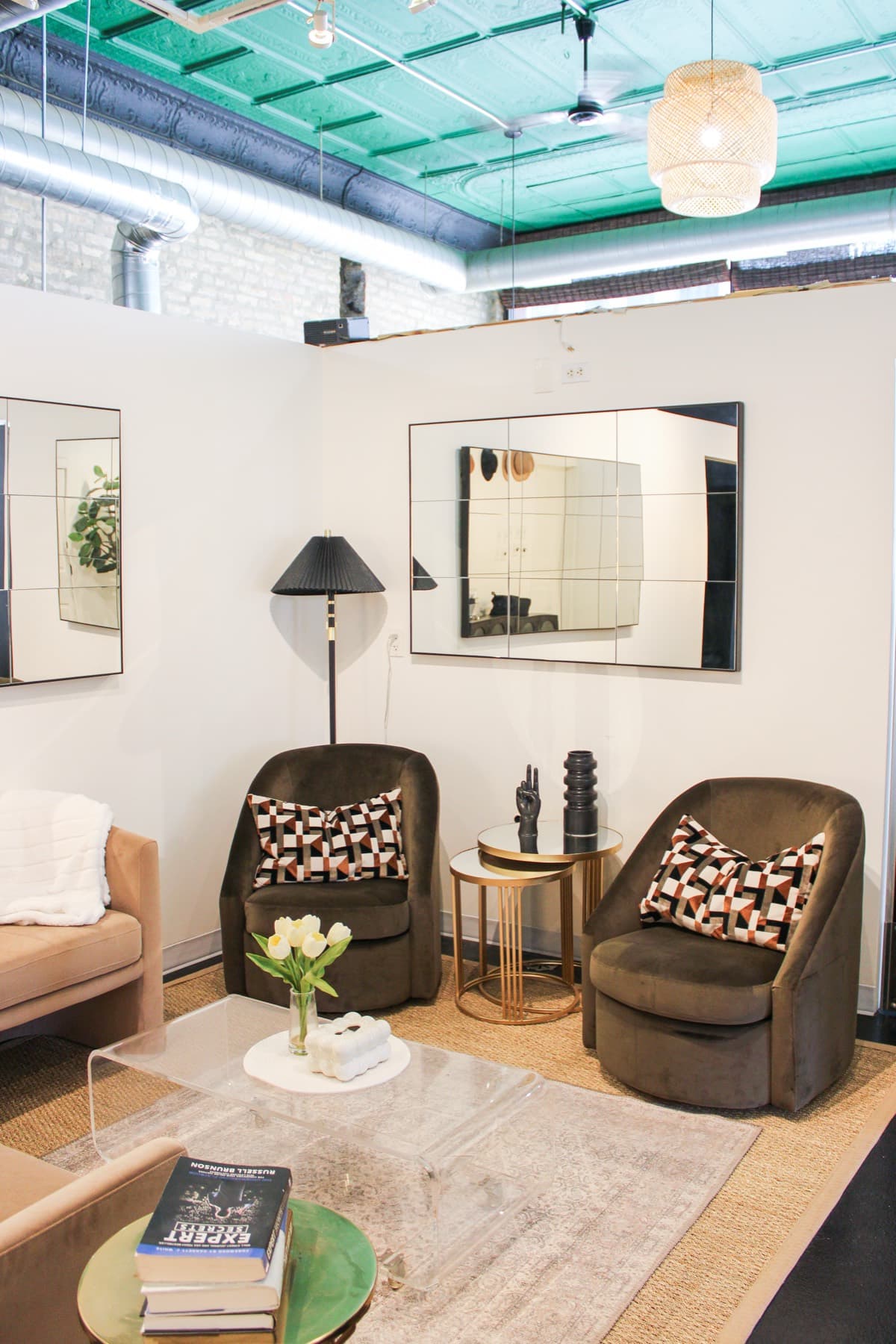 A considered guest lounge with velvet chairs