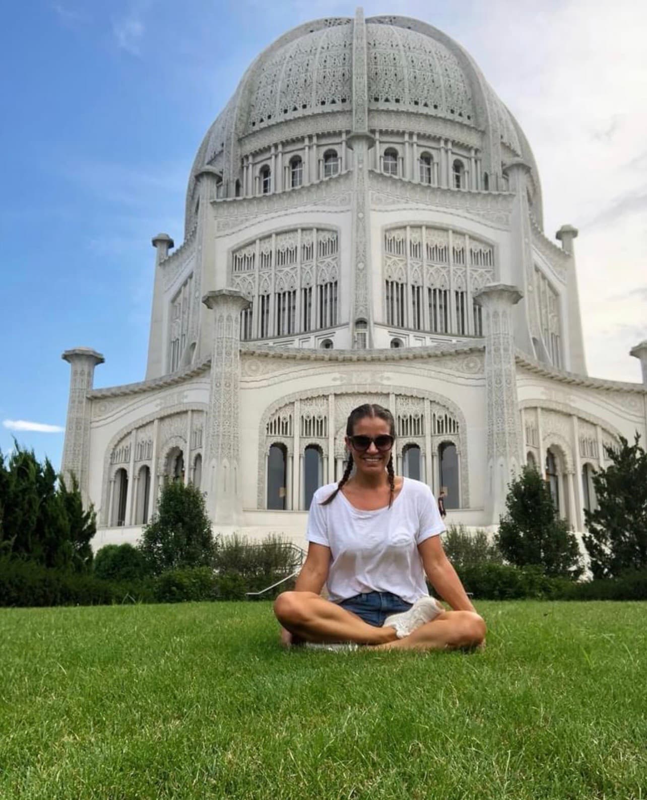 Jenn Dieas seated before the Bahá'í House of Worship in Wilmette